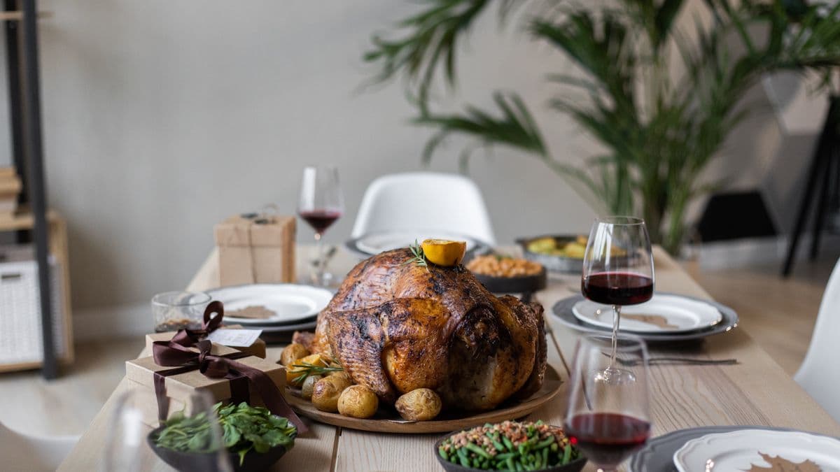 Roasted turkey and side dishes on a Thanksgiving dinner table.